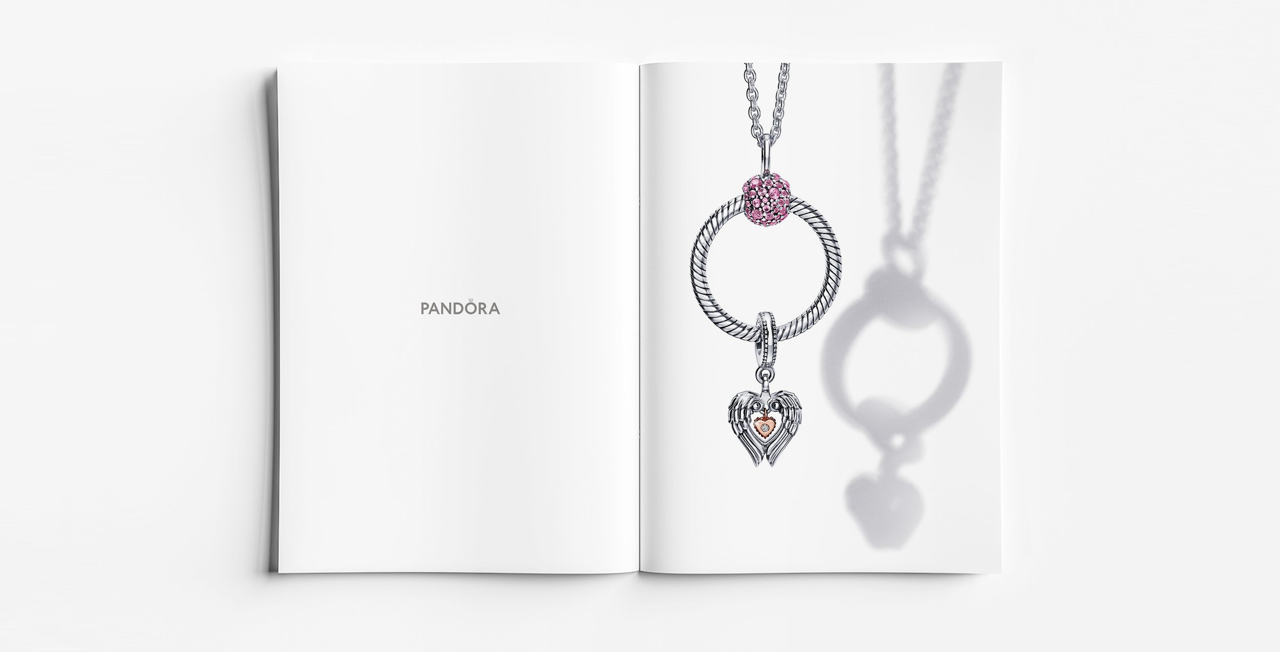 Pandora Moments winged heart Club Charm 2021 necklace in sterling silver with pink pavé clasp bead, jewellery design and product development by Myles Day Jewellery Artist.