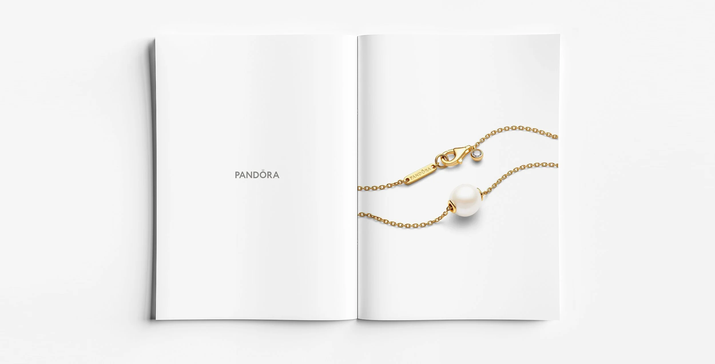 Pandora Pearls collection gold pearl bracelet with fine chain and solitaire pearl detail, contemporary jewellery design developed for Pandora by Myles Day Jewellery Artist.