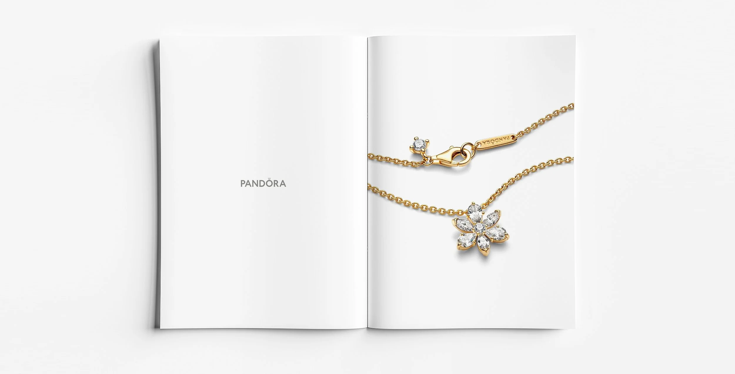 Pandora Herbarium gold pendant necklace with abstract botanical motif, shown alongside jewellery design drawing sketch, jewellery design by Myles Day jewellery artist.