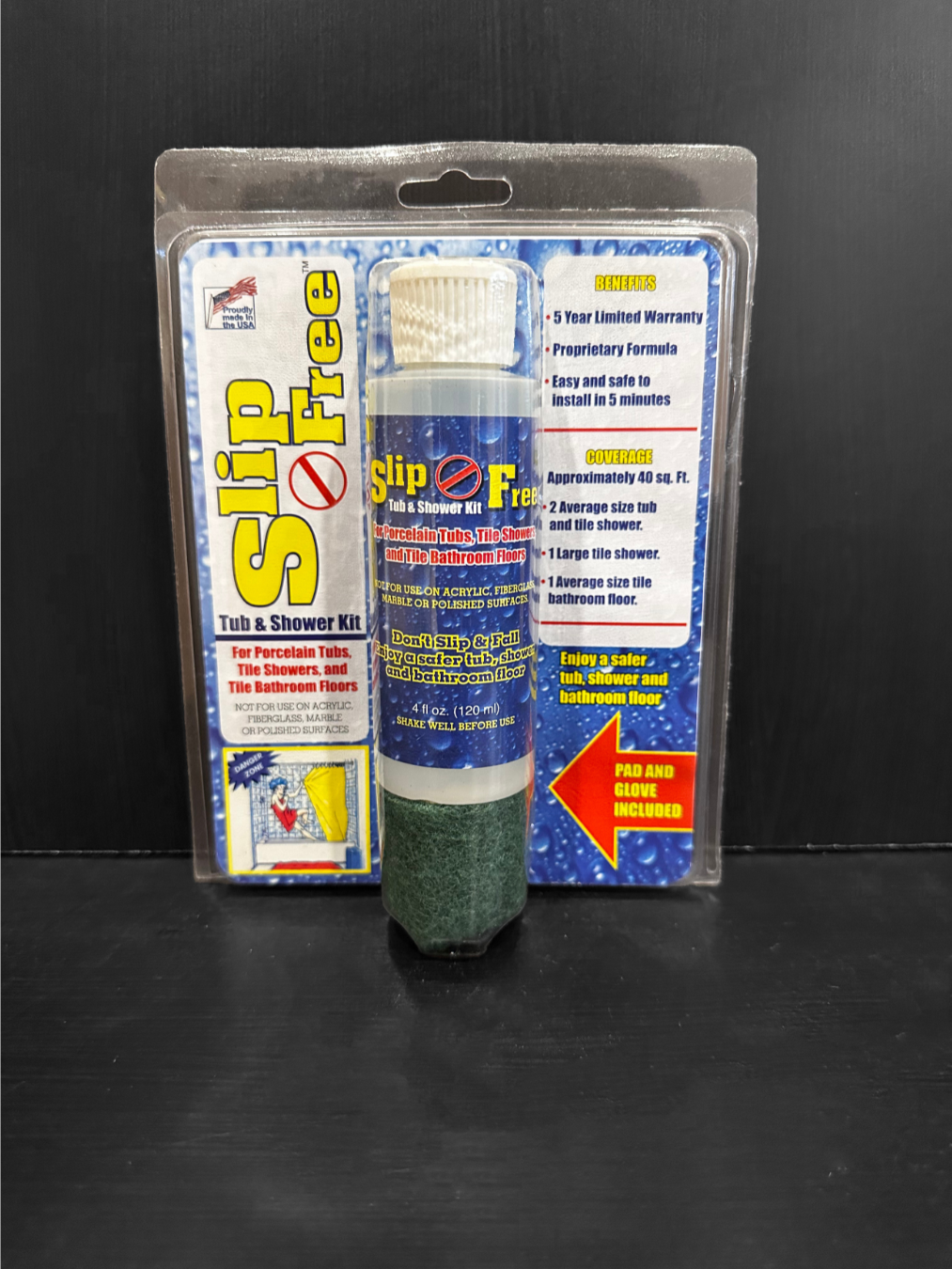 Modern wooden building with large glass window, set against mountainous landscape with dry grass and sparse bushes in foreground.