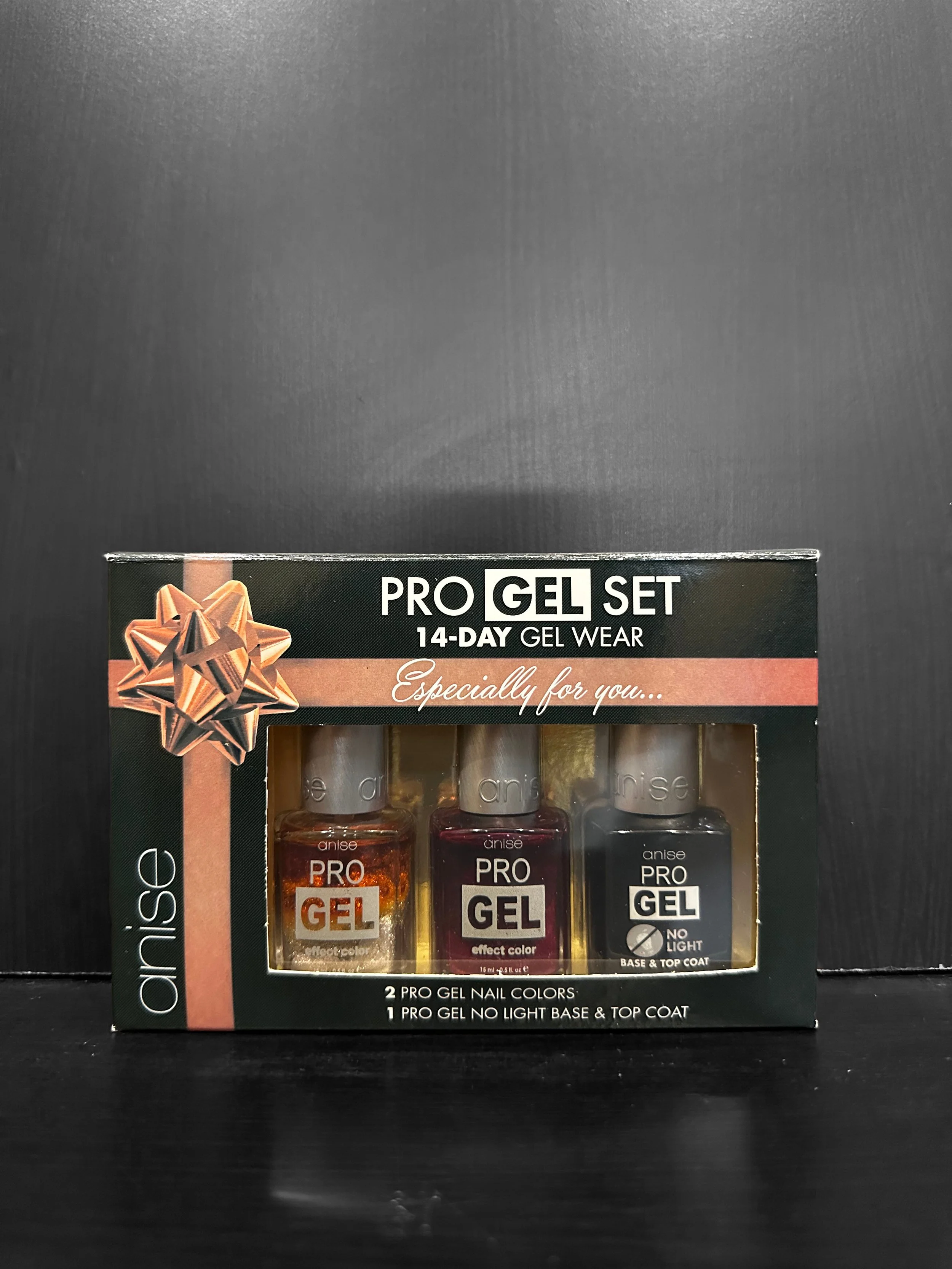 Mountain landscape with snow-capped peaks and rolling grassy hills, featuring a modern building in the foreground.