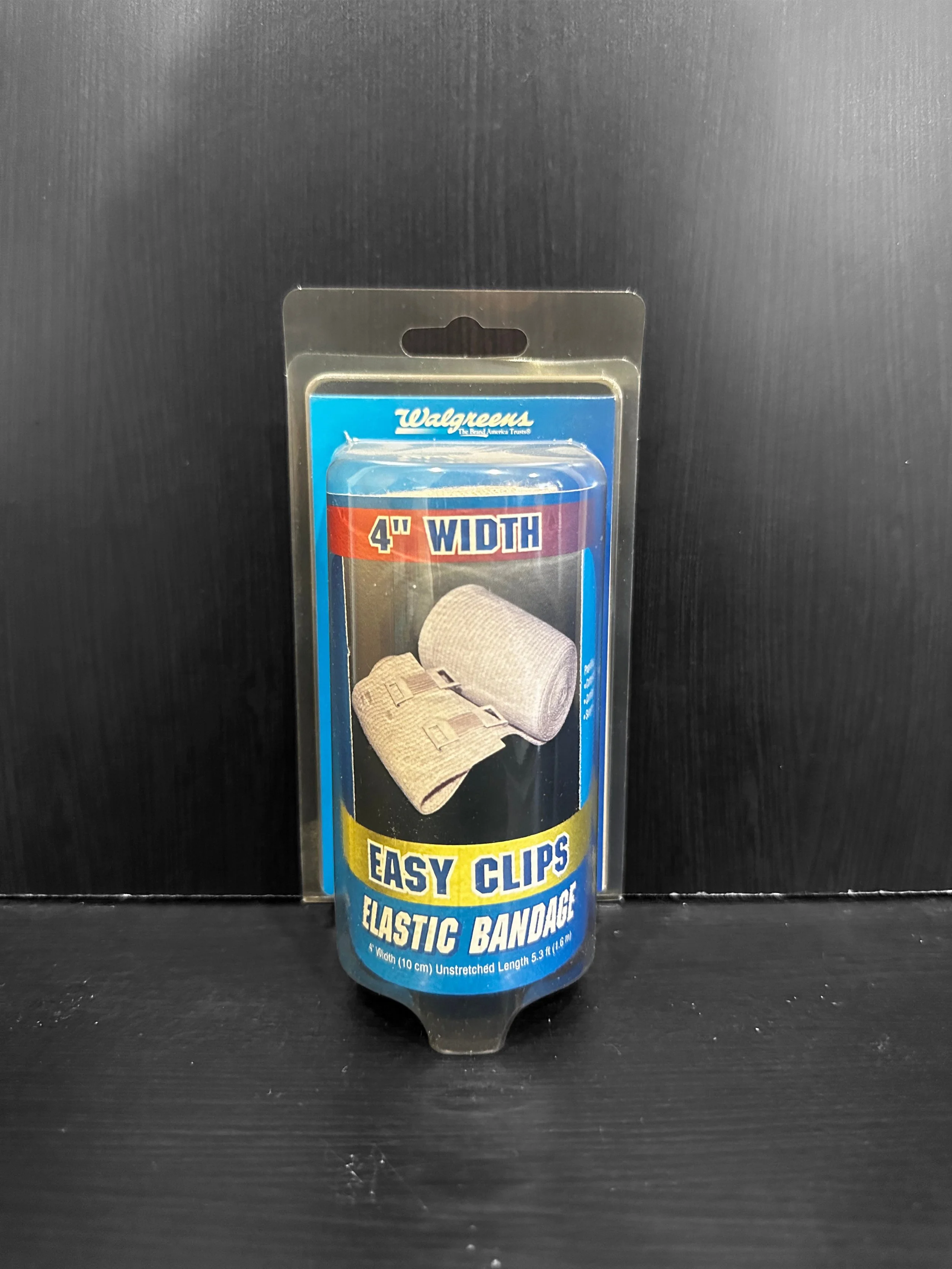 Scenic landscape of a large lake with mountains in the background, grassy hills in the foreground, and a cloudy sky.