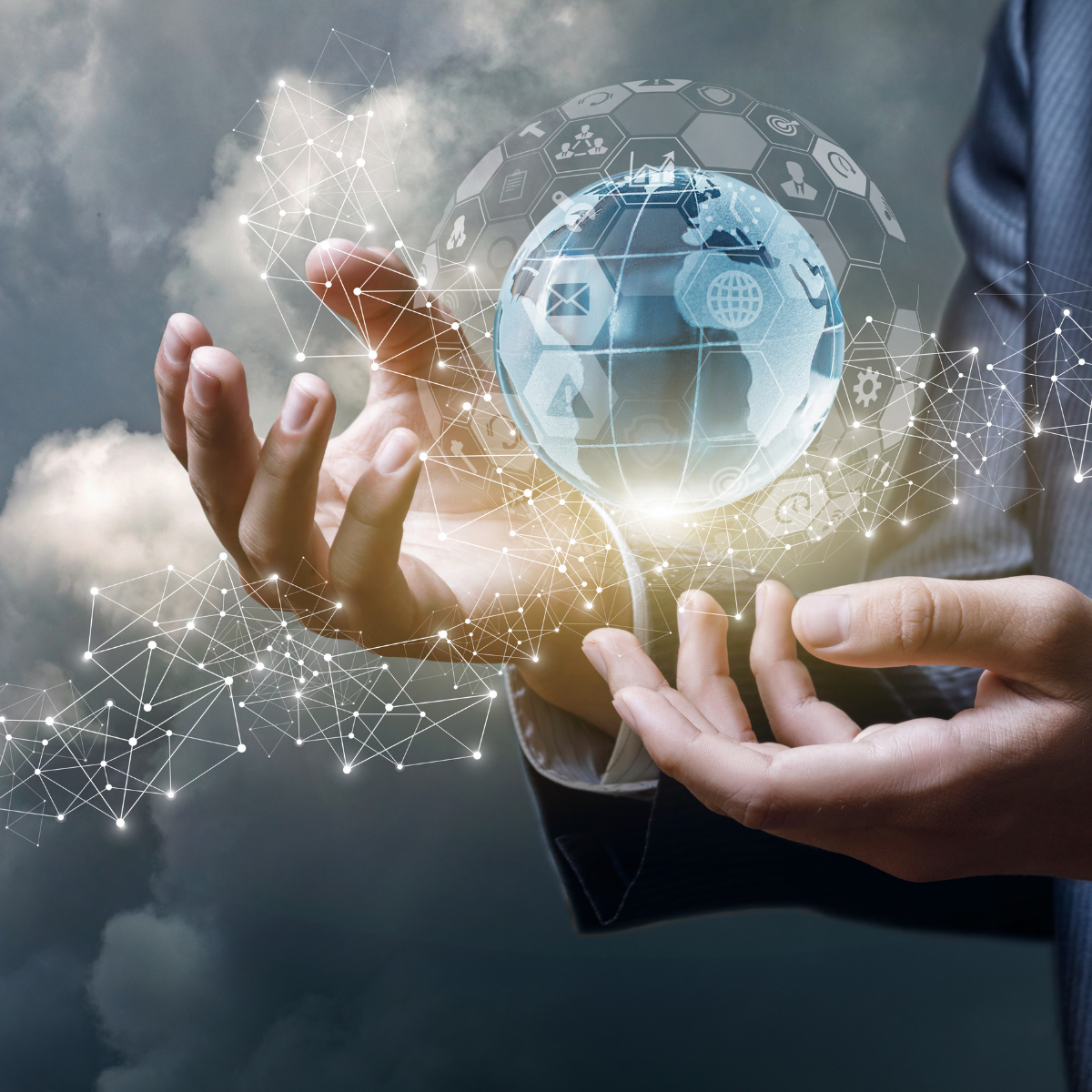 Person in a suit holding a holographic globe with interconnected digital icons and network lines around it, against a cloudy sky background.