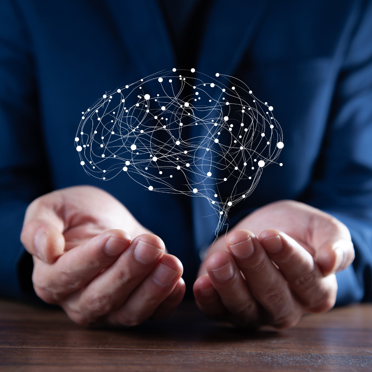 Person in a suit holding a holographic neural network representation in their hands.