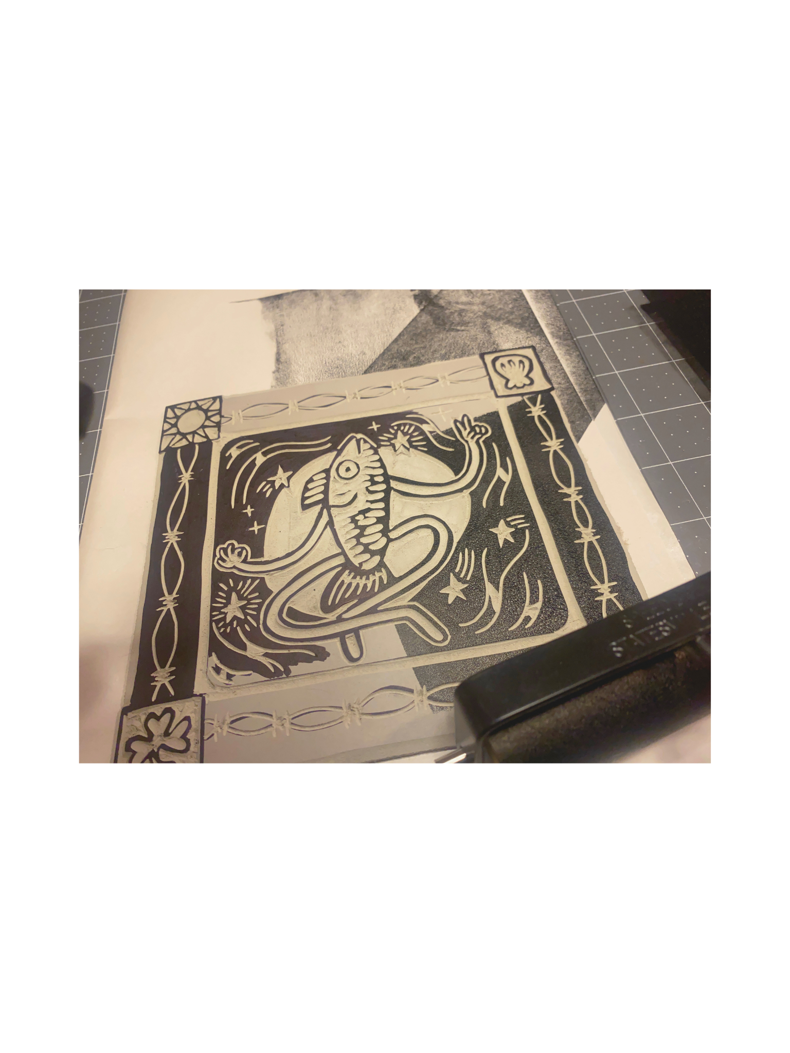 Stencil art featuring a dragon with a fish body, surrounded by stars and other decorative elements.