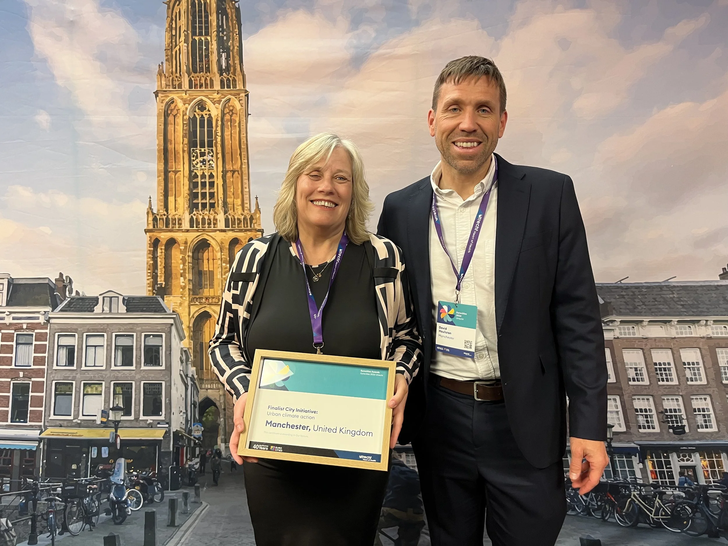 Cllr Tracey Rawlins and David Houliston smiling to camera holding the Urban Climate Initiative nomination certificate