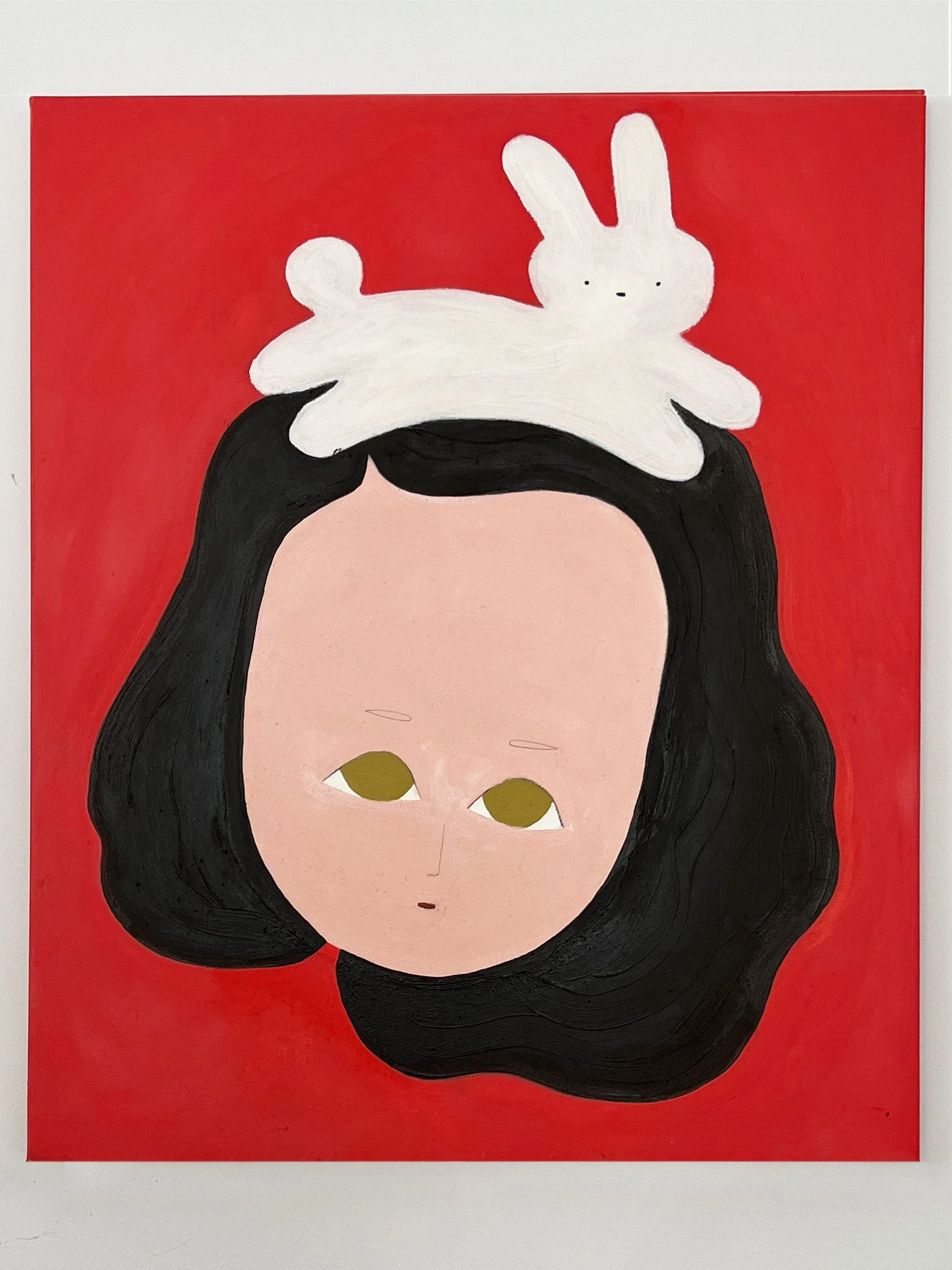 A painting of a girl with black hair and a neutral expression, against a red background, with a white rabbit on her head.