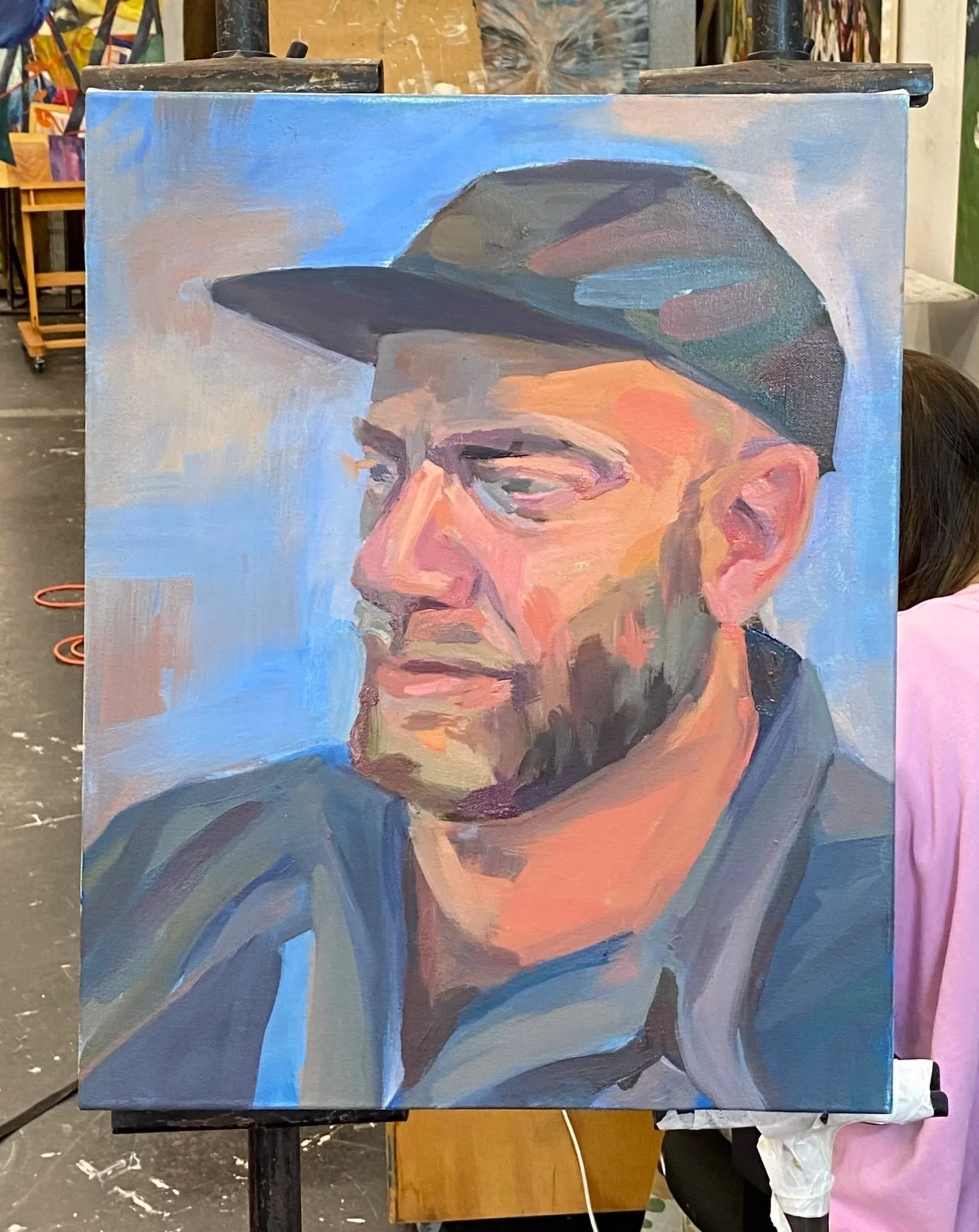 A portrait painting of a man wearing a cap, with glasses, a beard, and a mustache, in a semi-abstract style with broad brushstrokes and warm tones.