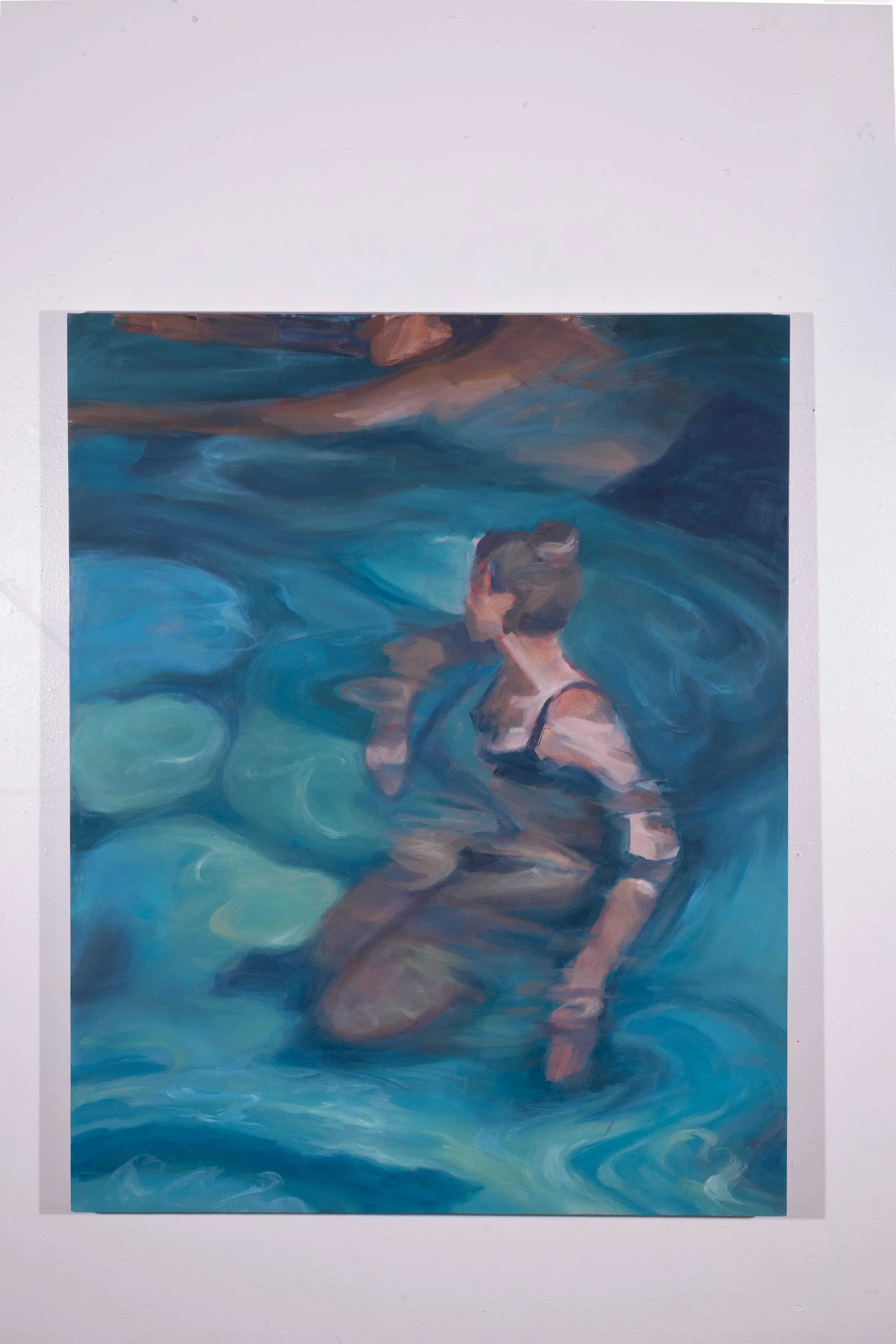 Painting of a woman with short hair in a black swimsuit, sitting in a pool with blue water, viewed from above.