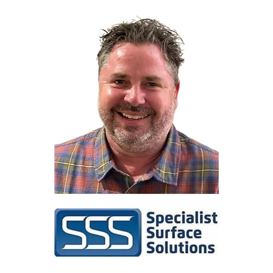 A smiling man with short, wavy hair and a beard, wearing a plaid shirt, positioned above a logo that says 'Specialist Surface Solutions' with the initials 'SSS' in a stylized font.