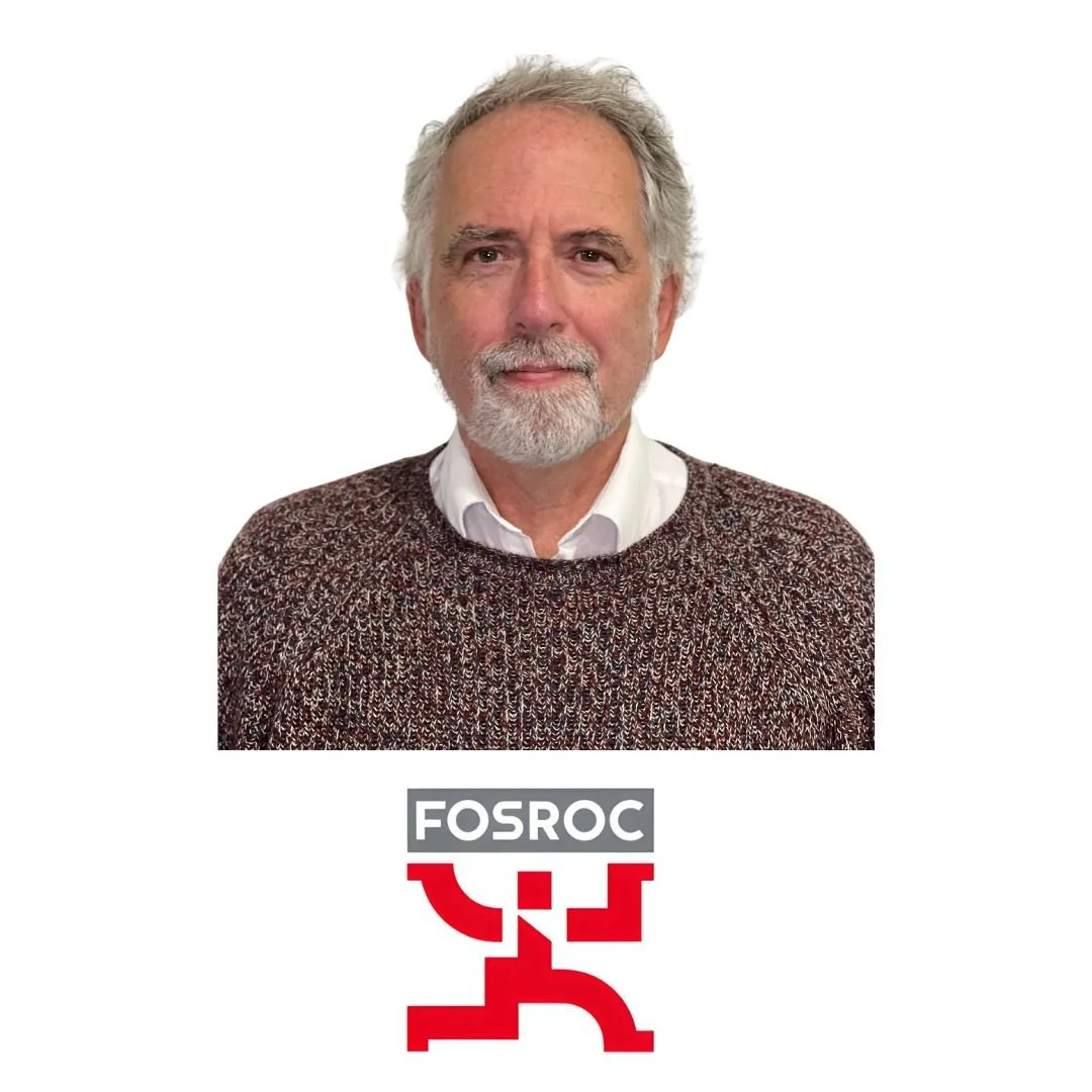 A man with gray hair and beard wearing a knit sweater and white collared shirt, standing above a logo that reads 'FOSROC'.