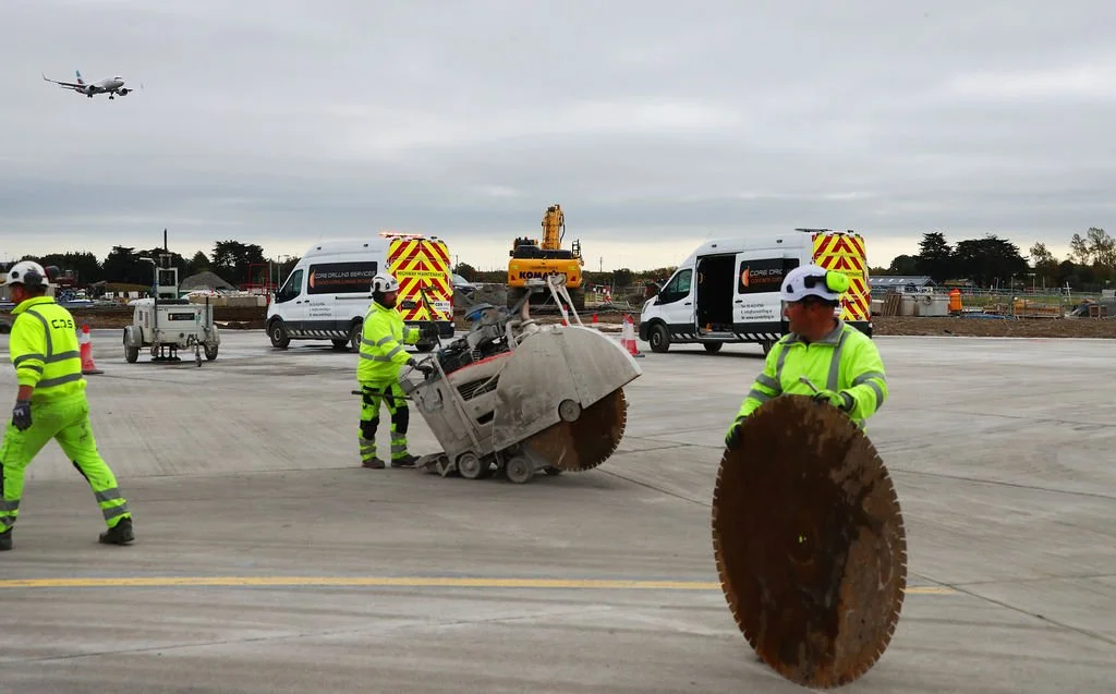 Saw cutting concrete pavement prior to joint sealing. 