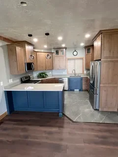 After: New drywall, kitchen cabinets, countertops, custom floor install and paint. Huntsville UT - VCON Restoration
