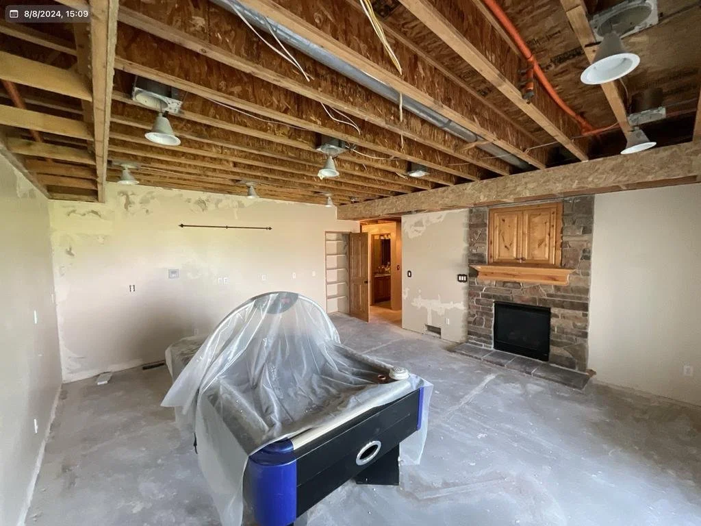 Before: major water damage on ceiling and walls in basement living room area– Huntsville, Utah VCON Restoration
