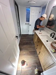 After: Finished basement bathroom featuring luxury vinyl flooring and new vanity – Clearfield, Utah restoration project