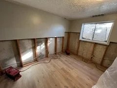Before: Water-damaged basement bedroom with old drywall in Clearfield, Utah – ready for complete rebuild by VCON Remodeling & Restoration