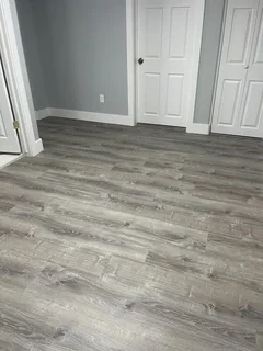 Finished basement with waterproof luxury vinyl plank flooring and fresh paint – Harrisville, UT complete restoration by VCON Remodeling & Restoration