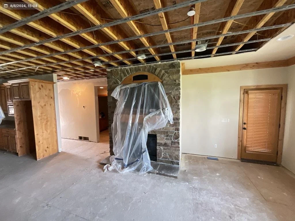 Before: major water damage on ceiling and walls in basement living room area– Huntsville, Utah VCON Restoration
