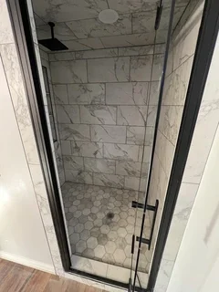 After: Finished basement bathroom with custom tile and glass shower door– Clearfield, Utah remodel by VCON Remodeling & Restoration