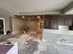 Before: Kitchen completely gutted with exposed ceiling joists and plumbing during demolition – Ogden, UT before full renovation by VCON