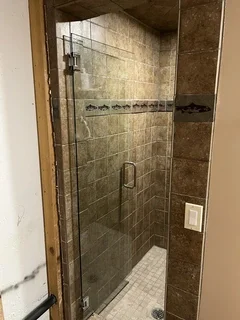 Before: Old tiled walk-in shower in basement bathroom before removal and remodel – Harrisville, Utah water damage restoration project