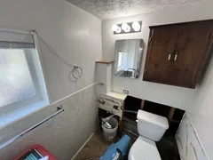 After: Completely restored bathroom with new vanity, modern mirror, luxury vinyl flooring and fresh paint after water damage – Brigham City, UT by VCON Remodeling & Restoration