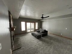 After: New drywall, paint, custom baseboard in basement living room area– Huntsville, Utah VCON Restoration
