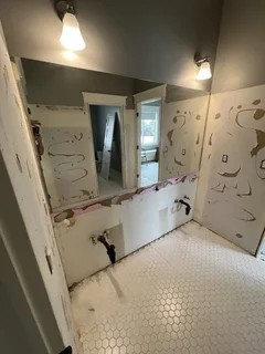 Before: Bathroom during full demolition with paneling and vanity removal – Ogden, Utah before complete remodel by VCON Remodeling & Restoration