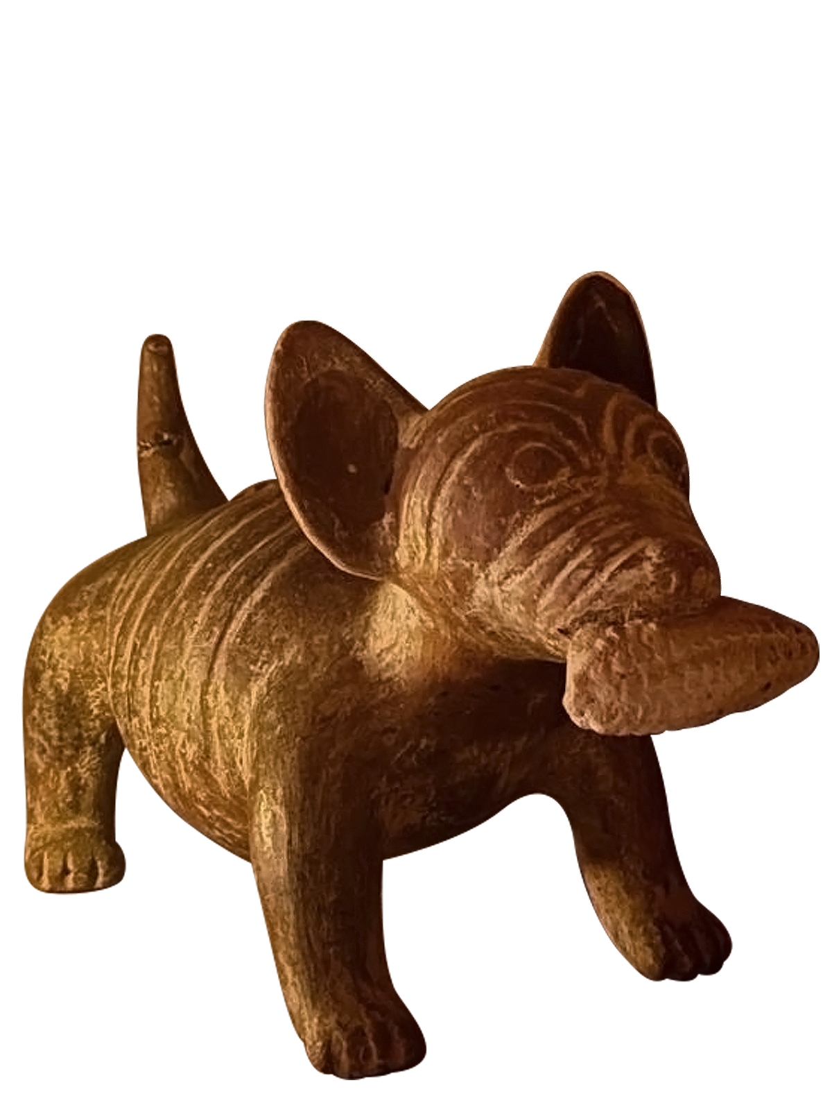 A carved wooden figure of a dog with large ears, a rounded body, and detailed facial features.