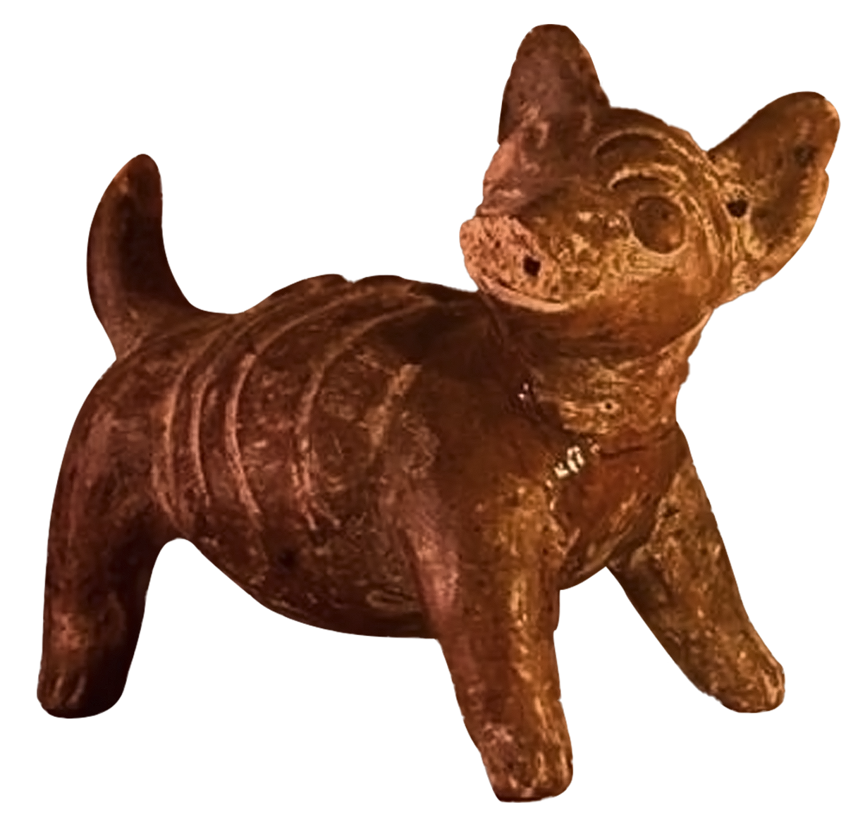 A carved sculpture of a cute animal, possibly a bear or dog, made from a reddish-brown stone with a textured surface.