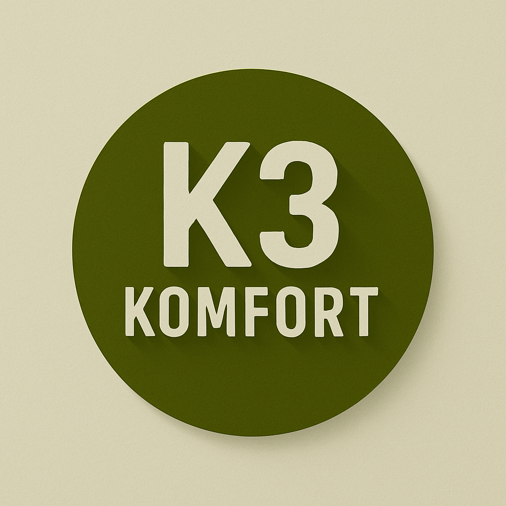 Green circular sign with white text reading 'K3 KOMFORT' mounted on a wall.