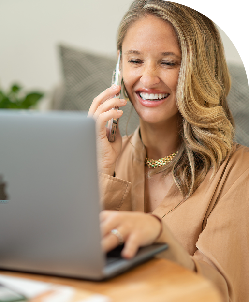Theresa Peterson smiling on a client call while using her laptop, offering straightforward financial planning and annuity guidance.