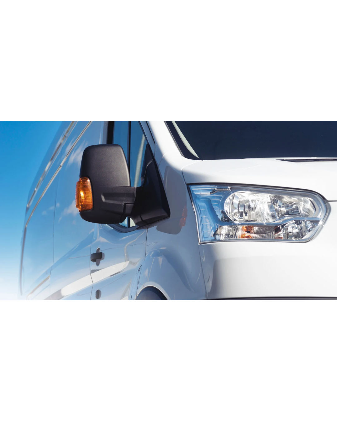 Close-up of a white commercial van front, showing headlight, orange turn signal, and side mirror against a clear blue sky.
