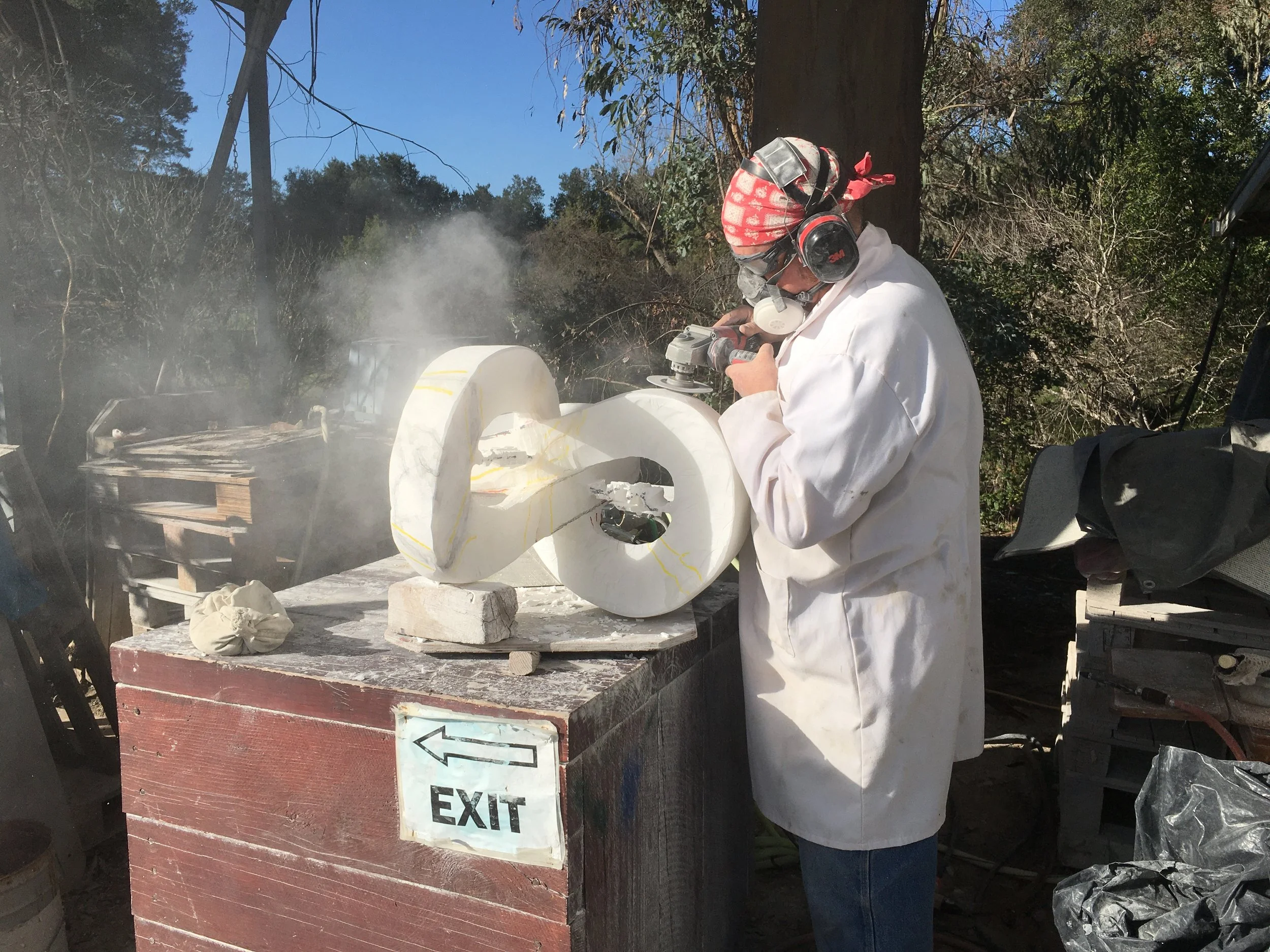 T Barny grinding a stone sculpure