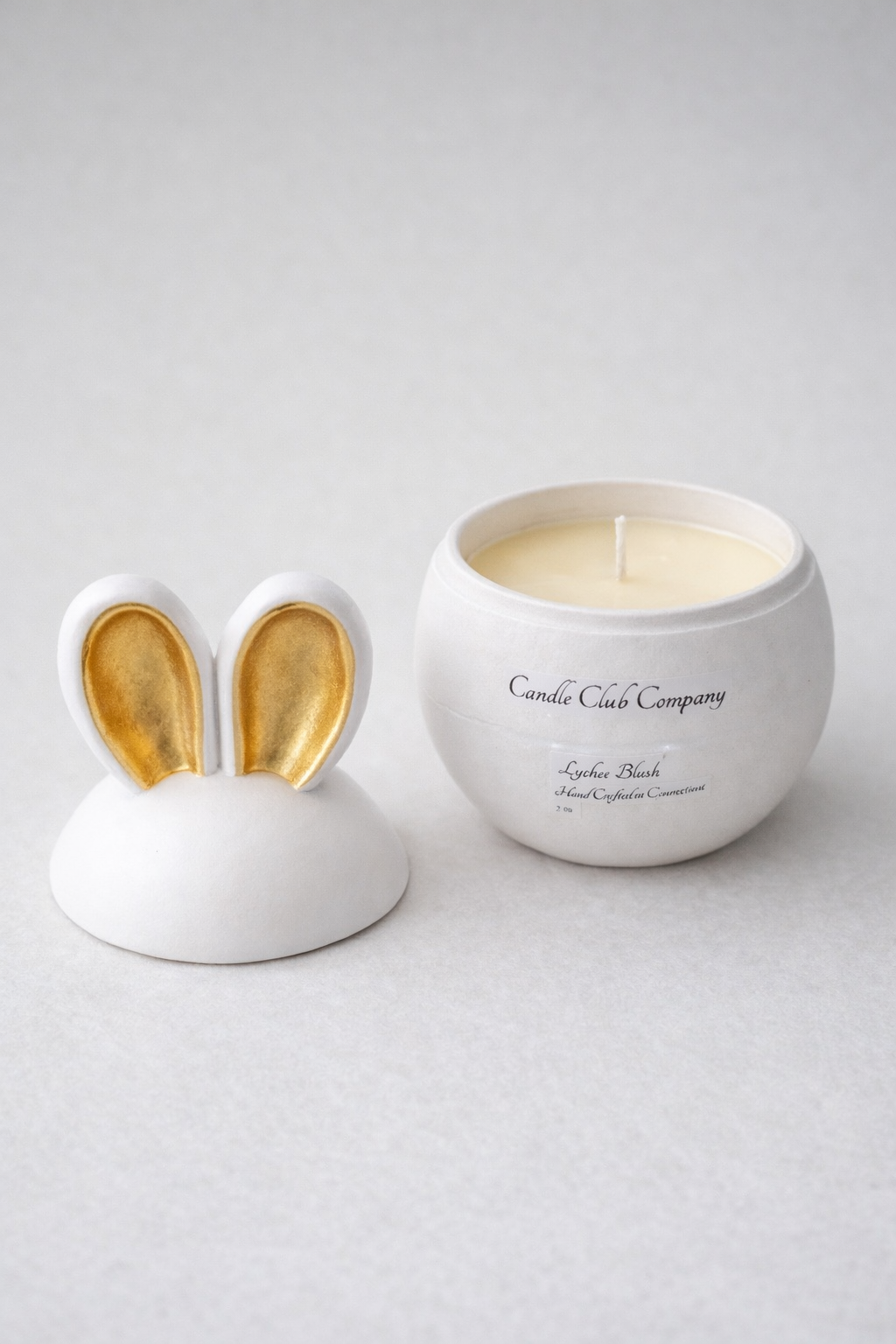 Luxury gold ear bunny candle open with lid beside it, handcrafted Easter candle from Connecticut small business