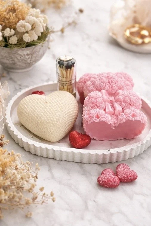 Handmade heart candle and floral bear candle displayed on decorative tray, romantic gift set presentation