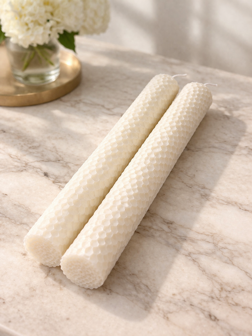 10 inch ivory soy taper candles with textured finish on marble surface