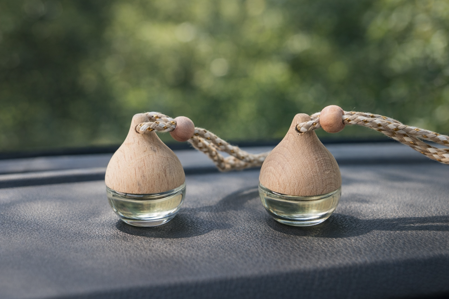 Signature hanging car diffuser with natural wood top and glass bottle, refillable car air freshener