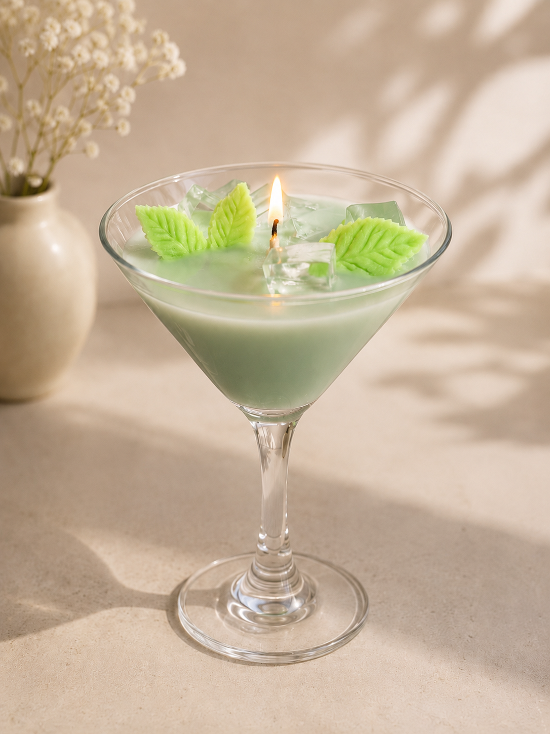 Luxury Mint Mojito Martini candle in a glass martini vessel with mint leaf wax embeds and realistic ice cube accents.