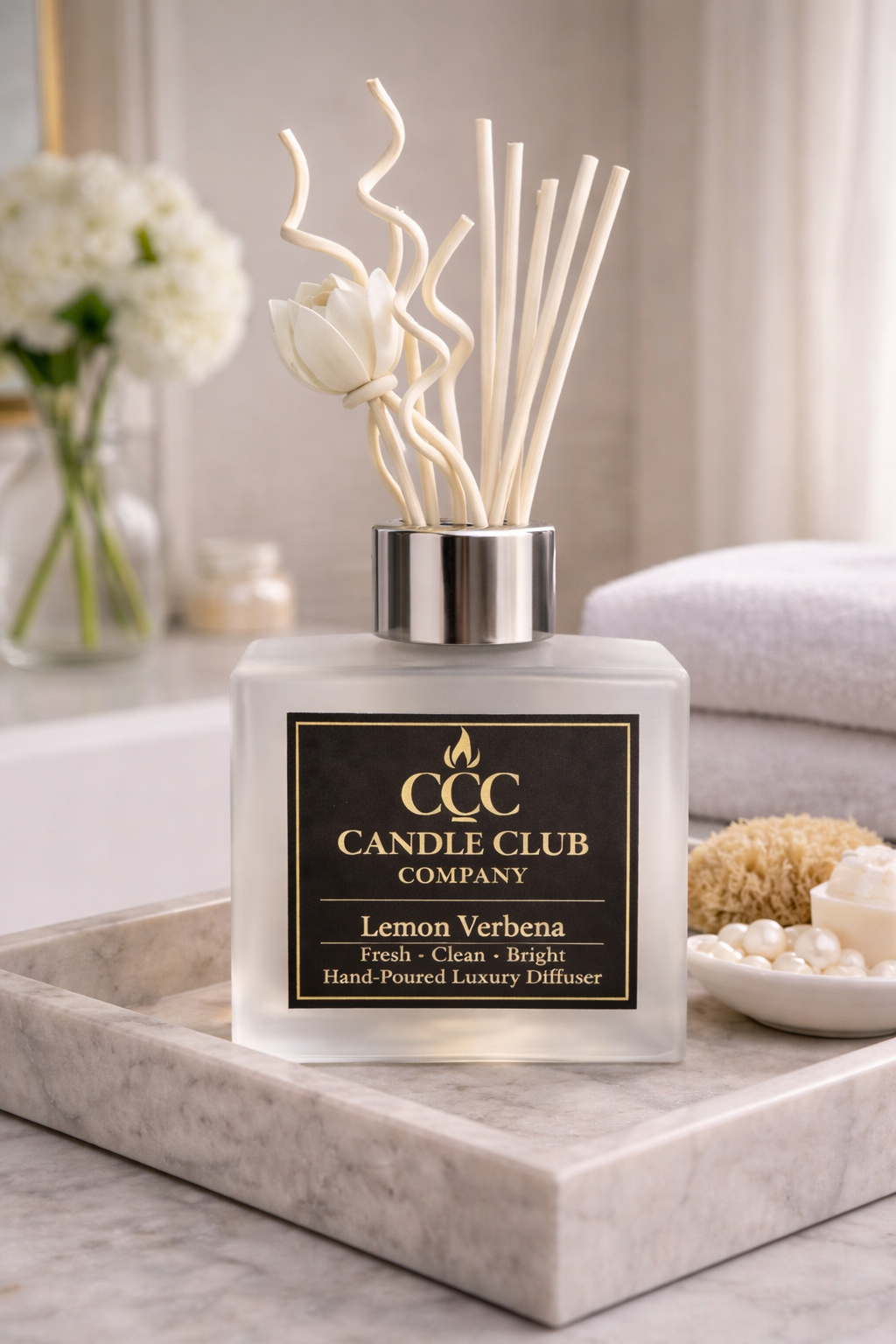 Luxury reed diffuser styled on marble tray in bathroom with towels and decor, creating a clean spa-like home fragrance atmosphere