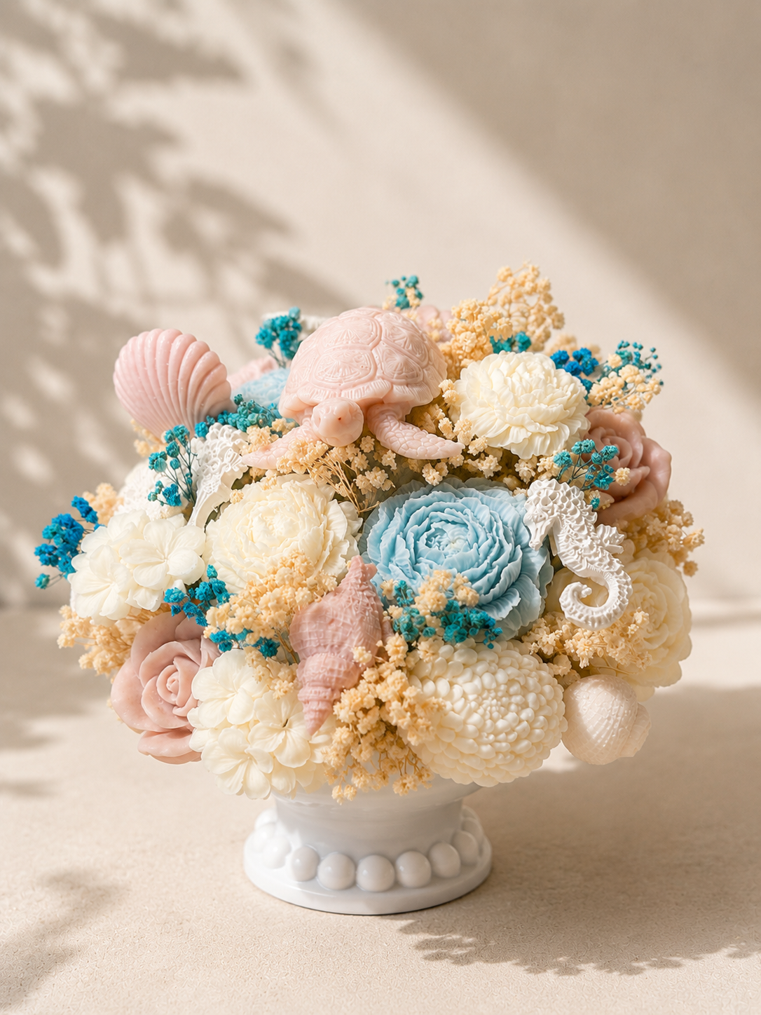 Luxury coastal candle bouquet with floral wax details and seashell accents