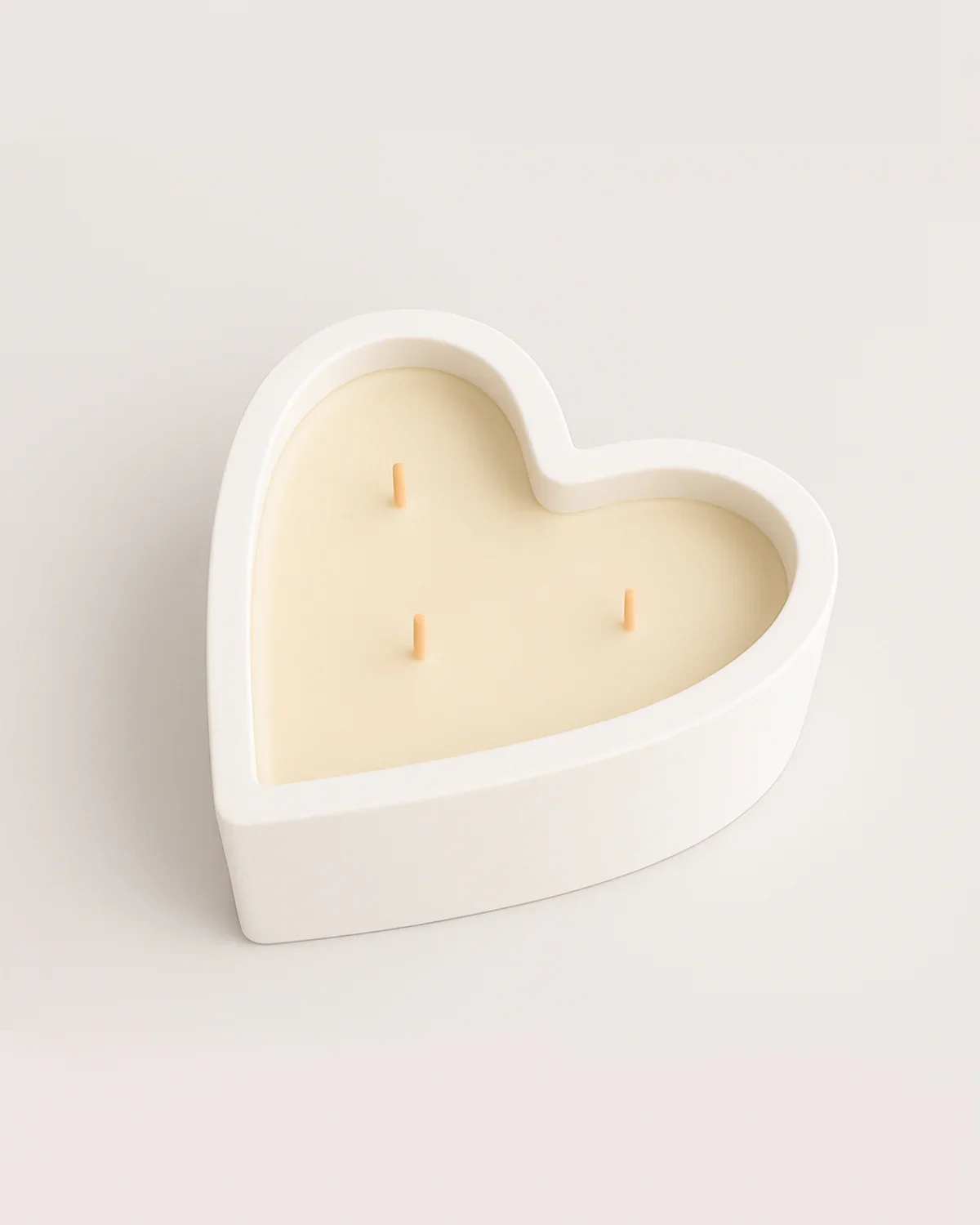 White heart-shaped 10 oz soy candle with three cotton wicks in a modern concrete vessel, handcrafted candle made in Connecticut, minimalist candle design