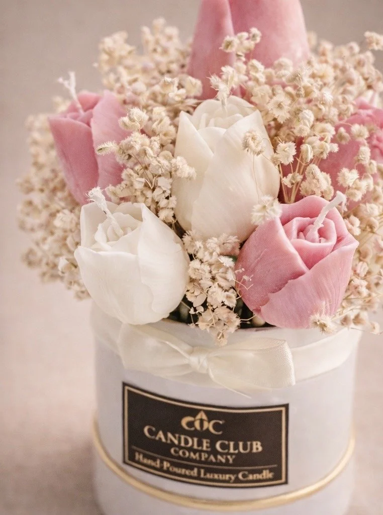 Close-up of handcrafted wax tulip flowers in a luxury soy candle bouquet with soft neutral background, premium floral candle design