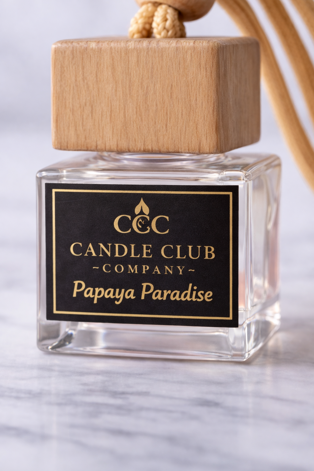 Close up luxury car diffuser bottle with black and gold Candle Club Company label