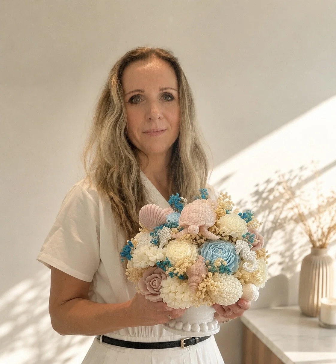 Founder of Candle Club Company holding handmade botanical candle bouquet in Connecticut