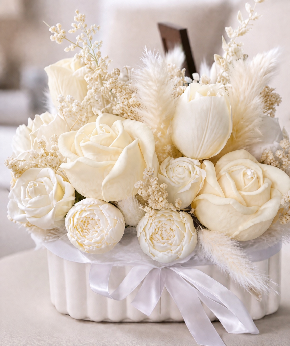 All ivory floral candle arrangement with detailed wax roses in a white vessel, elegant neutral home décor centerpiece