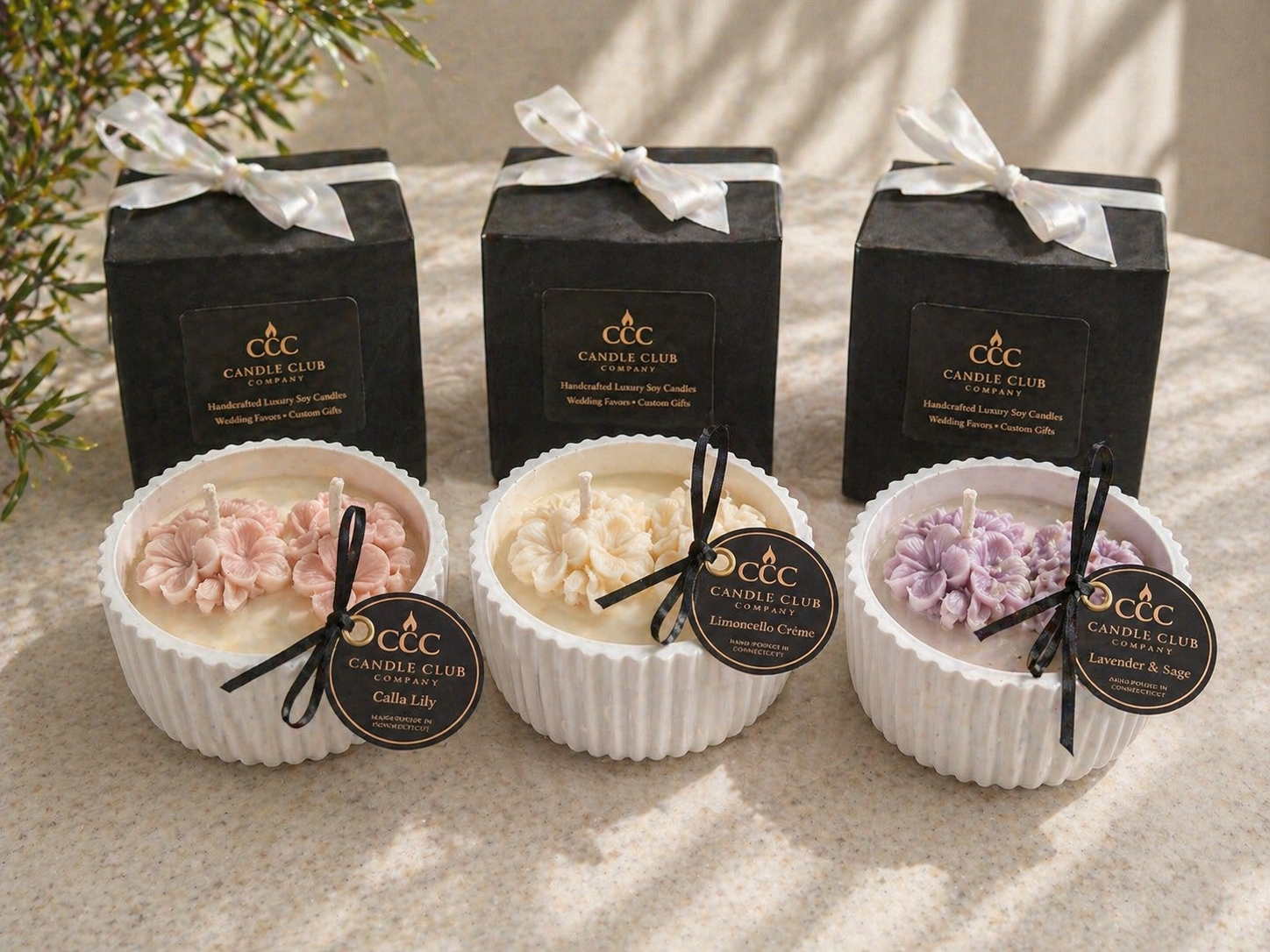 Candle Club Company floral candle collection with gift boxes, featuring blush pink, ivory, and lavender candles on a neutral lifestyle background.