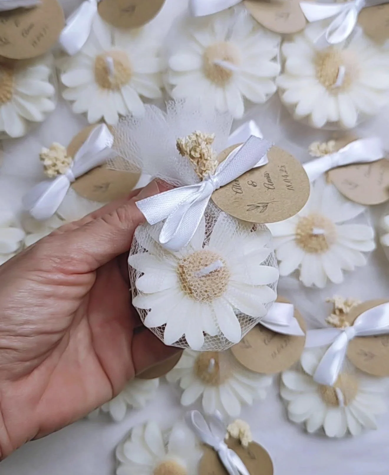 Handcrafted flower-shaped soy candle favor wrapped in white tulle with ribbon and custom tag, perfect for wedding, bridal shower, or baby shower favors by Candle Club Company.