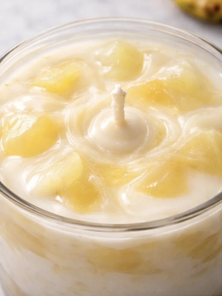 Close-up of Piña Colada soy candle wax texture with swirled pineapple-inspired design and cotton wick detail