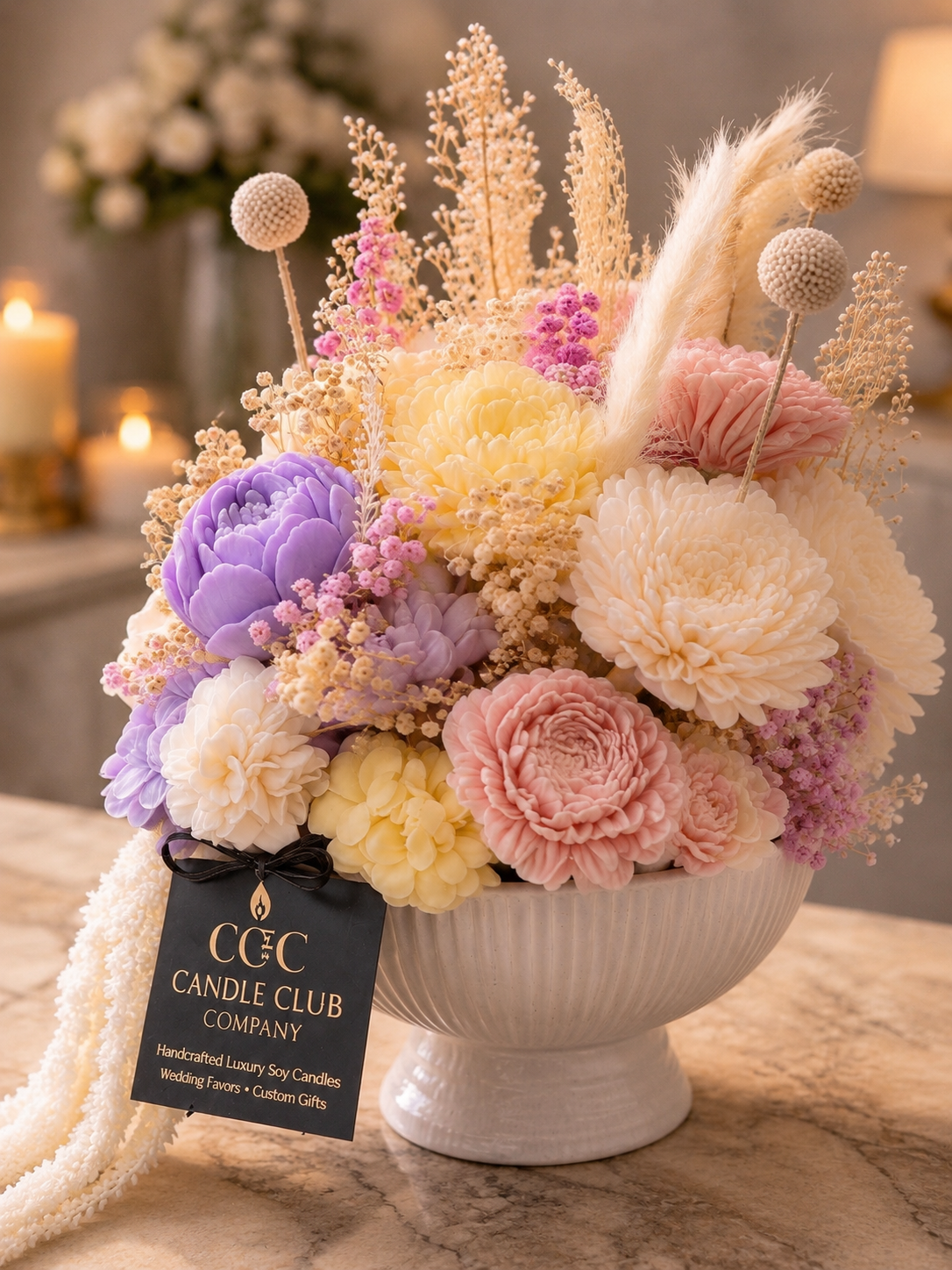 Luxury floral candle centerpiece by Candle Club Company featuring pastel pink, cream, and lavender flower candles in a n elegant white vessel, styled with soft pampas accents and warm romantic lighting in Connecticut.